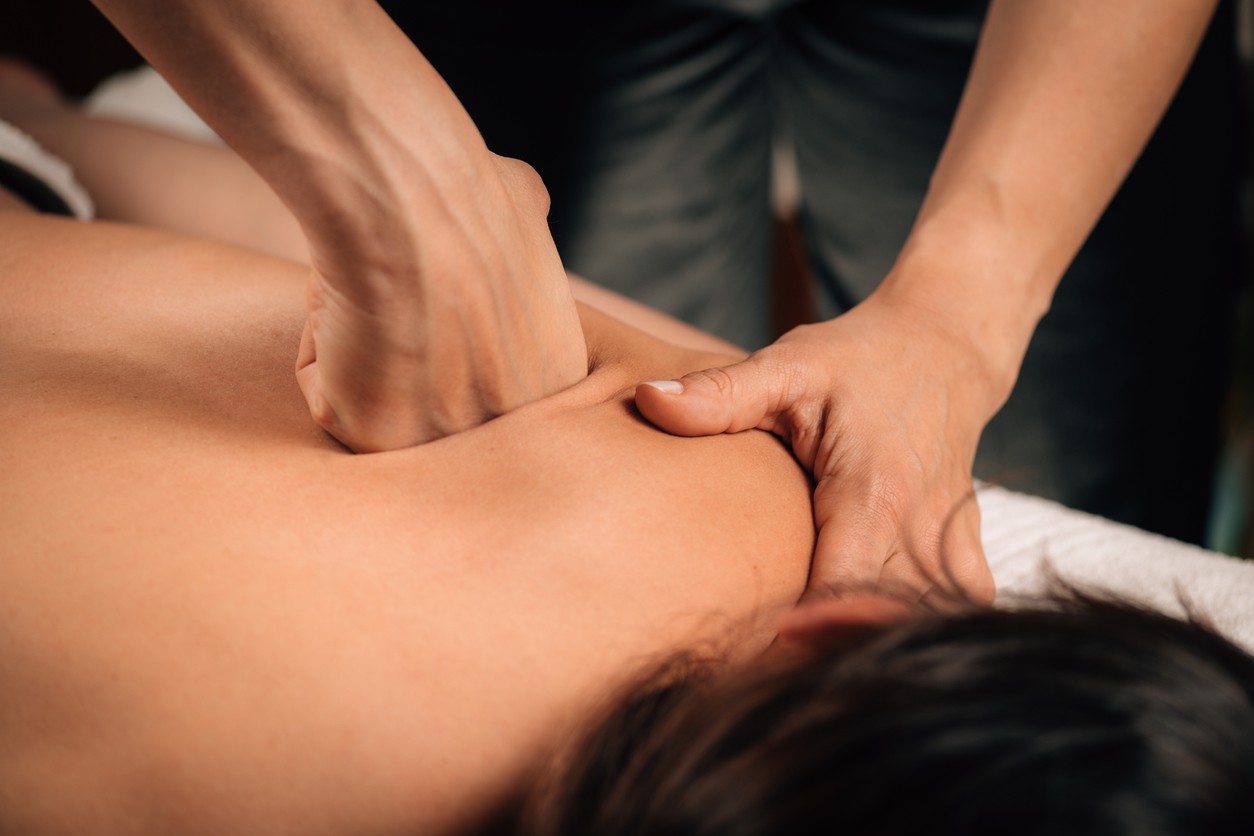 Deep pressure being applied along the shoulders and back