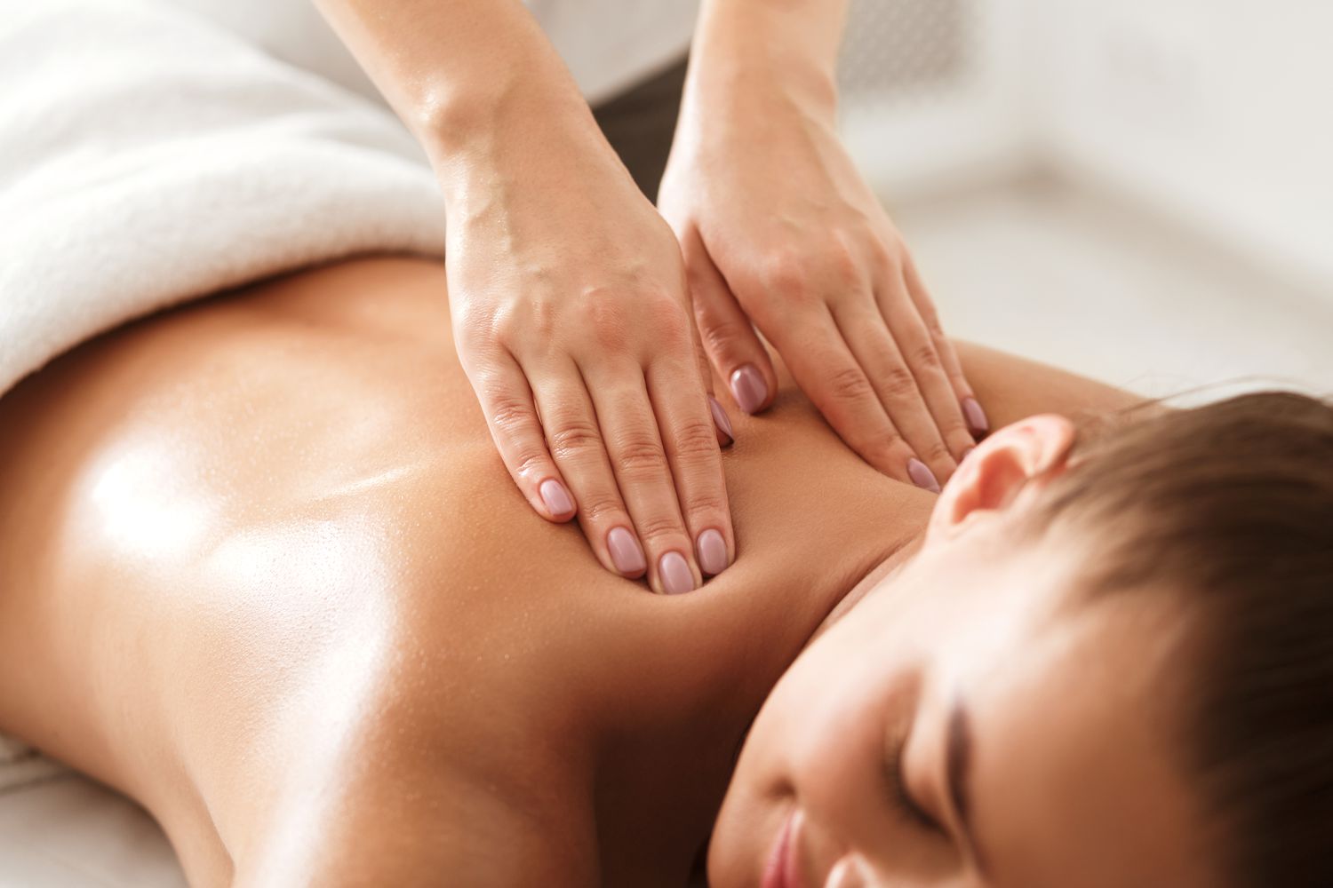 Therapist kneading a guest’s back